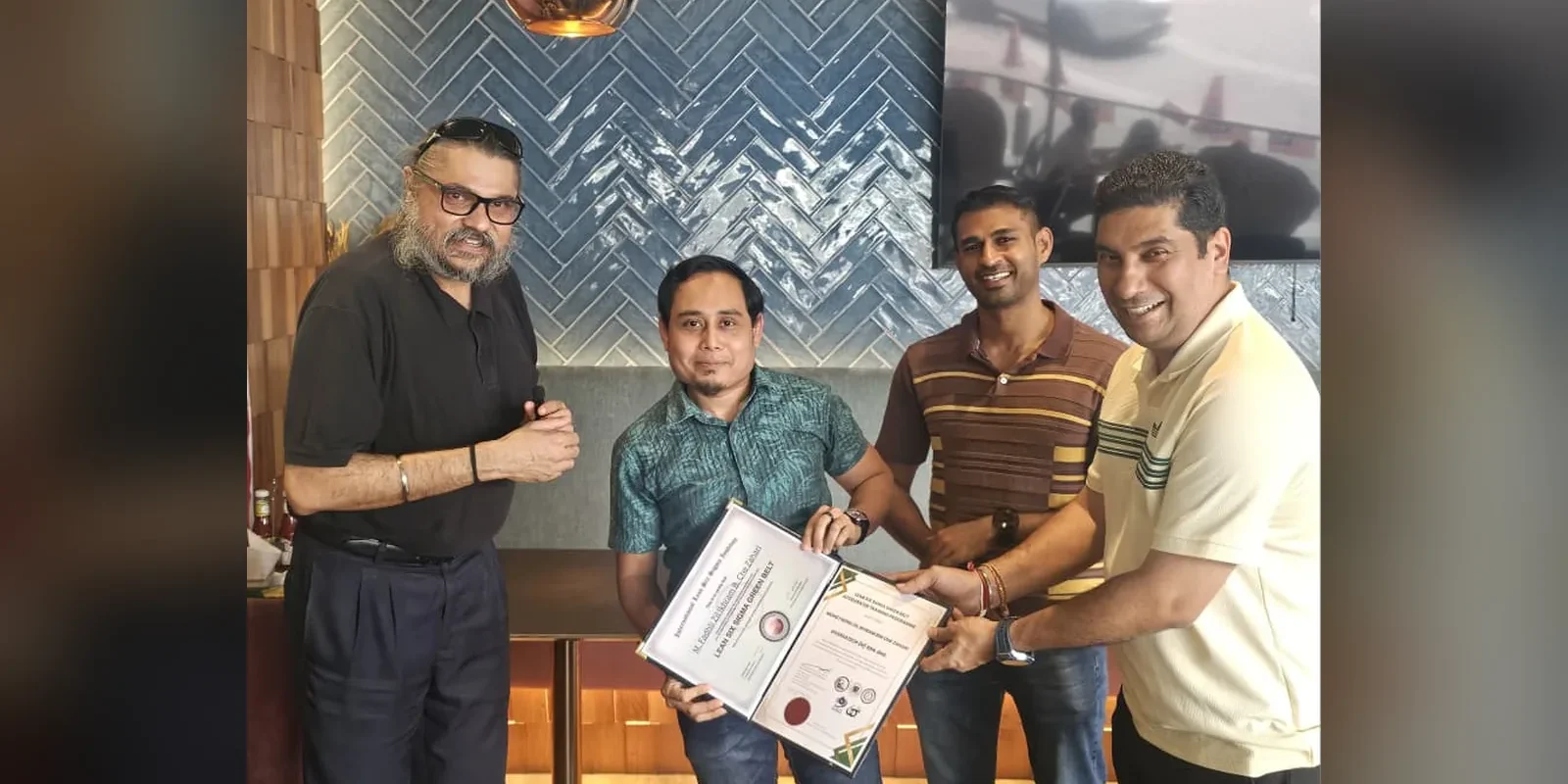 MBizM first ILSSI Lean Six Sigma Green Belt certified professional Mr. Mohd Fadhli Zil Ikhram receiving his ILSSI Lean Six Sigma Green Belt certificate at the MBizM Gathering Ceremony